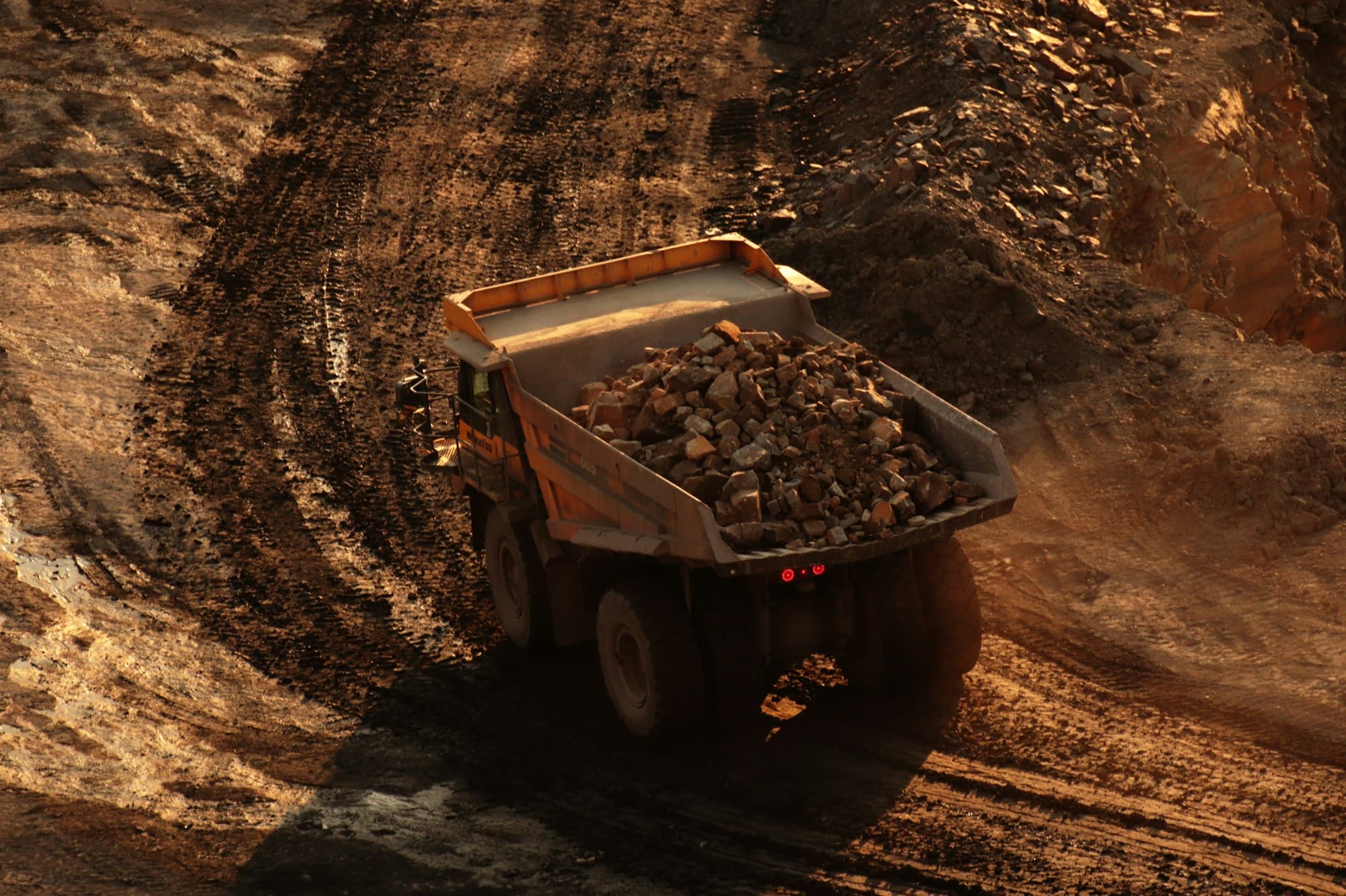A loaded haul truck carrying broken rock on a quarry road. This is not a photograph of the SPR fleet.